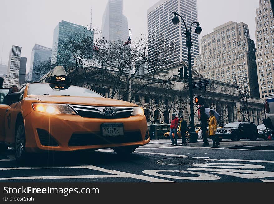 Yellow Toyota Sedan on in Highway Road