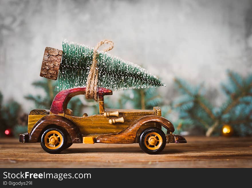 Vintage toy wooden machine carries a Christmas tree. Vintage toy wooden machine carries a Christmas tree