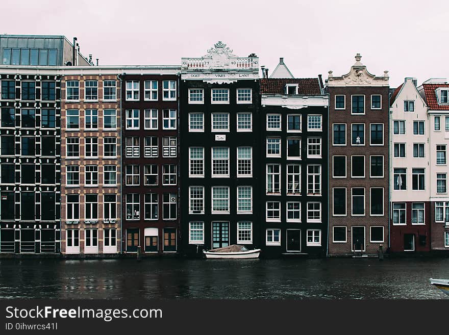 White Sailboat Beside Concrete Building