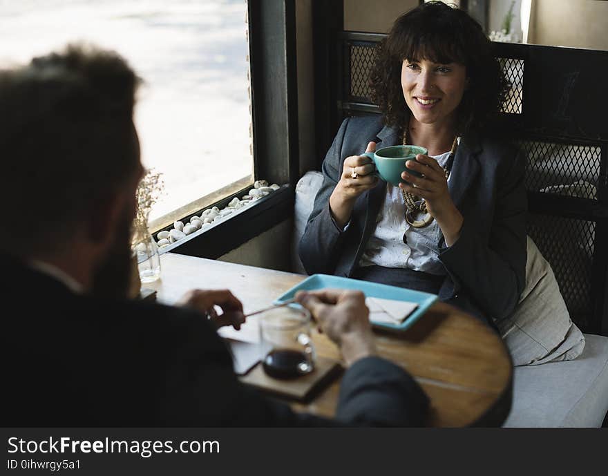 Woman in Black Blazer Holding Blue Cup