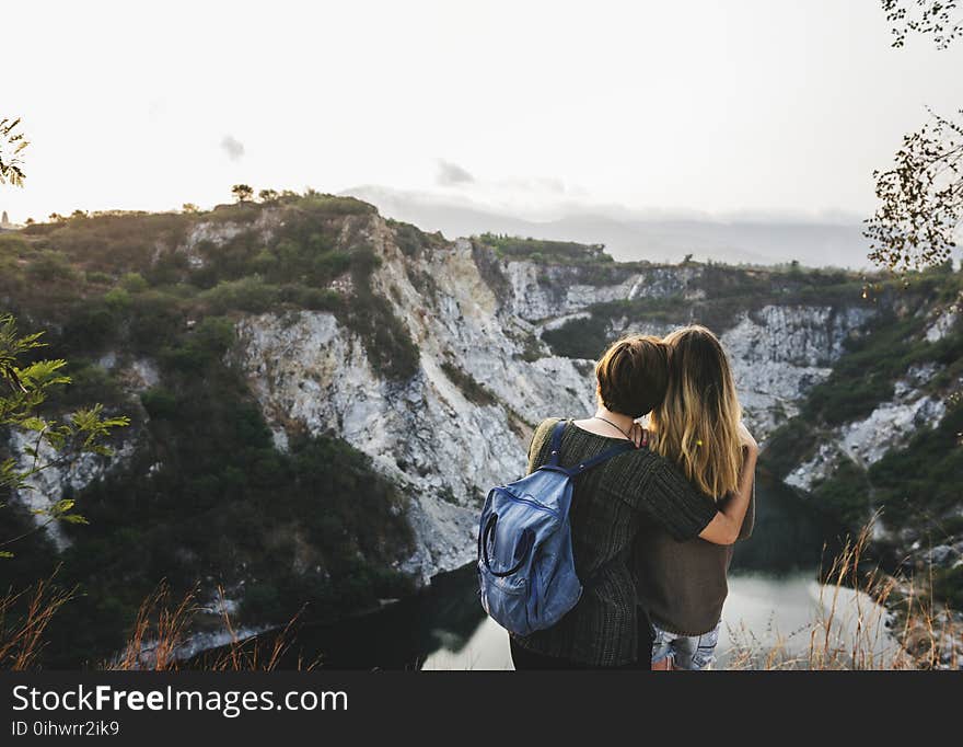 Two Woman Standing on the Ground and Staring at the Mountain