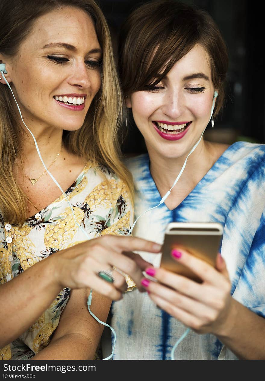 Two Girls Using Iphone