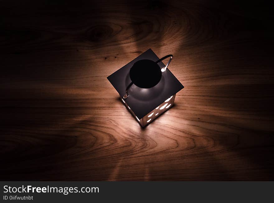 Gray Steel Candle Lantern on Brown Wooden Board