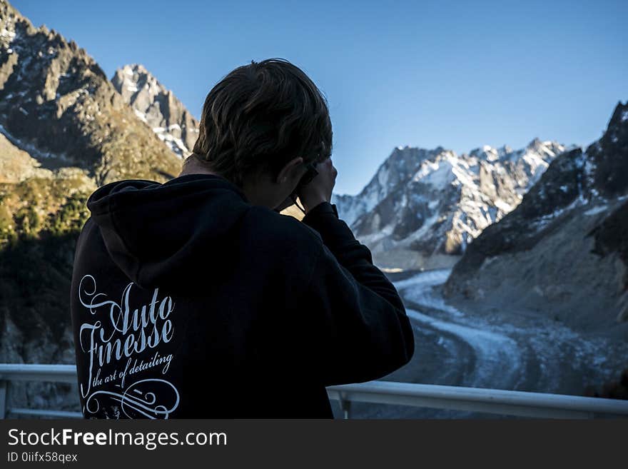 Man in Black Hoodie Holding Camera