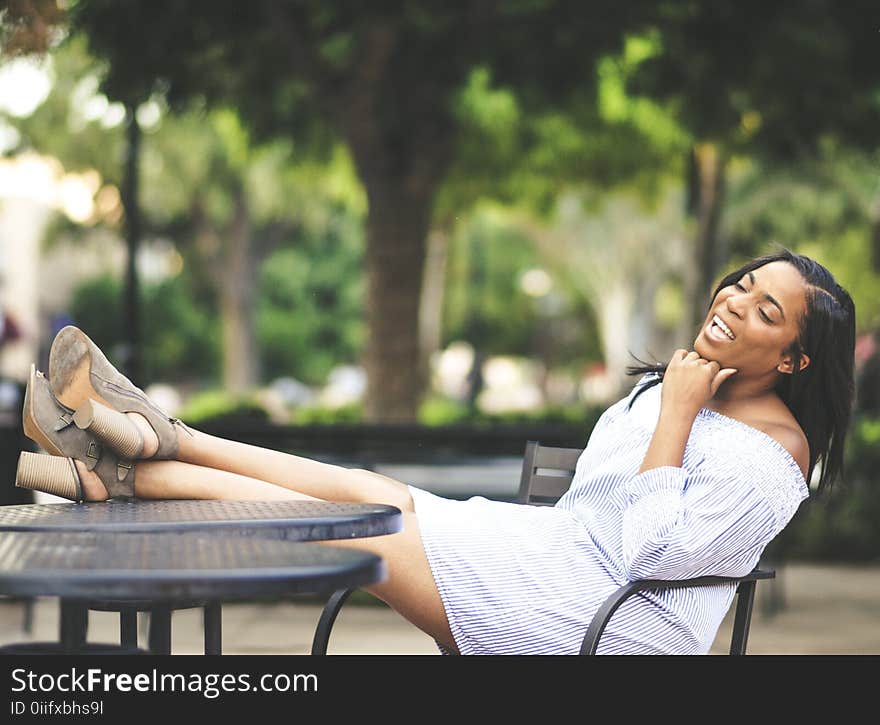 Shallow Photography on Woman Sitting on Chair