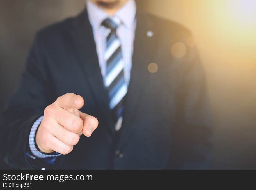 Close Up Photo of a Person Wearing Suit Jacket