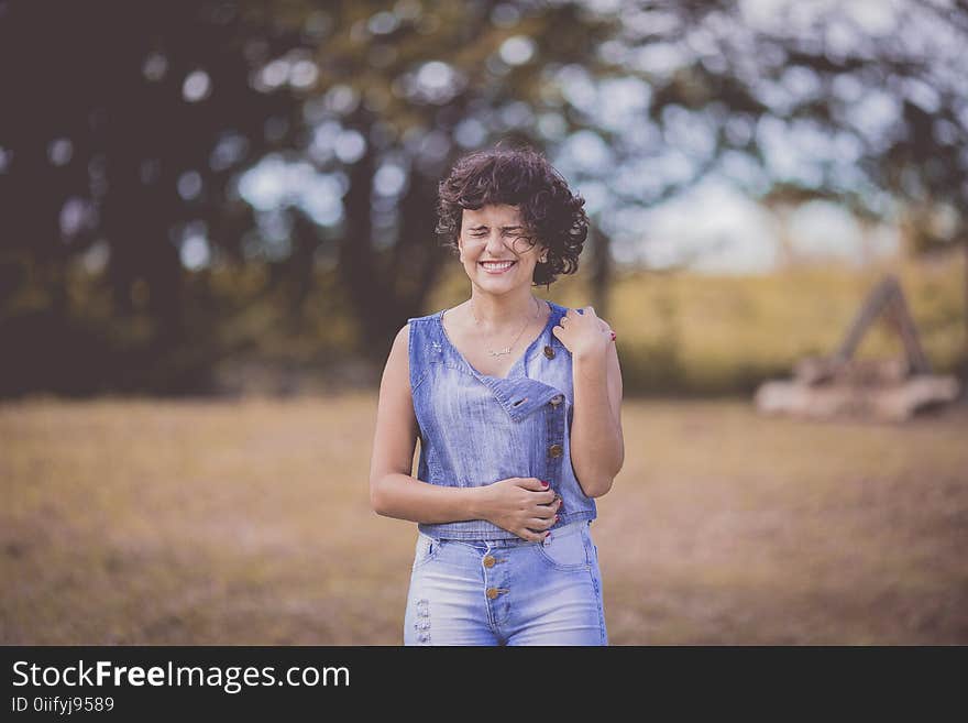 In Distance Woman Wearing Blue Scoop-neck Sleeveless Top and Blue Denim Bottoms