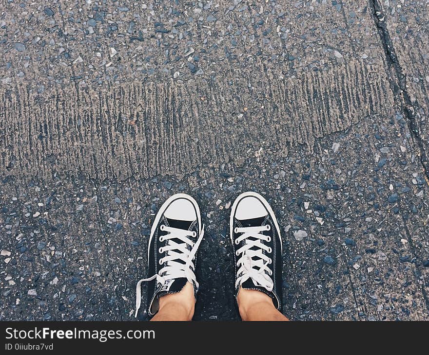 Person Wearing Pair of Black-and-white Converse All Star Low Sneakers