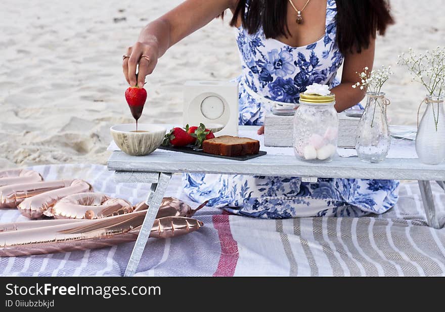 Woman Wearing Blue and White Floral Sleeveless Dress