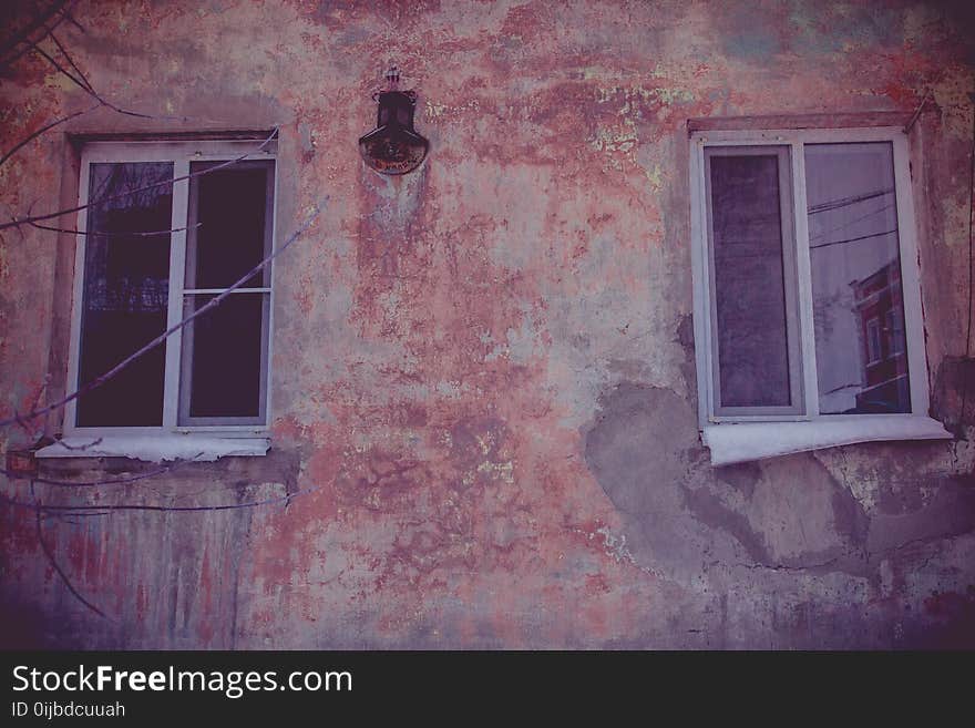 Old walls with cracked plaster and two windows. Old walls with cracked plaster and two windows.