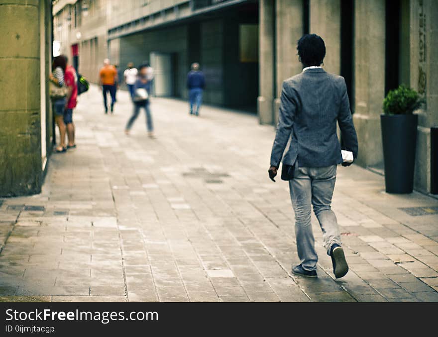 Man Wearing Gray Suit Jacket While on Pathway