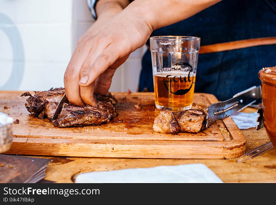 Person Slicing Grilled Meat