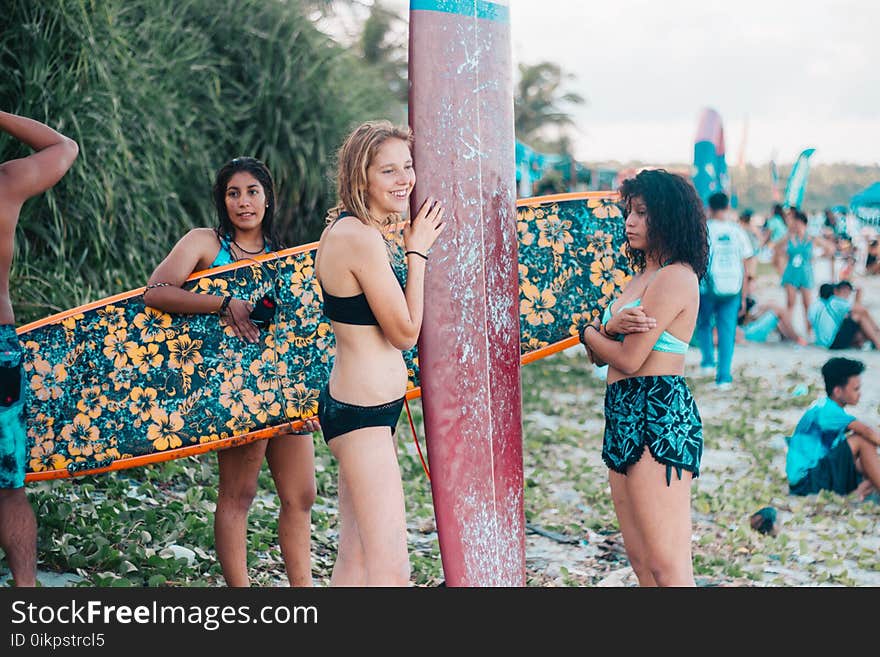 Women Wearing Black While Holding Surf Boards