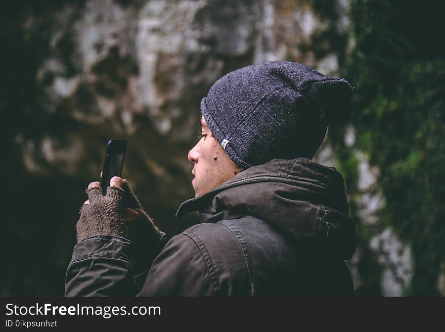 Man Wearing Beanie Holding Smartphone