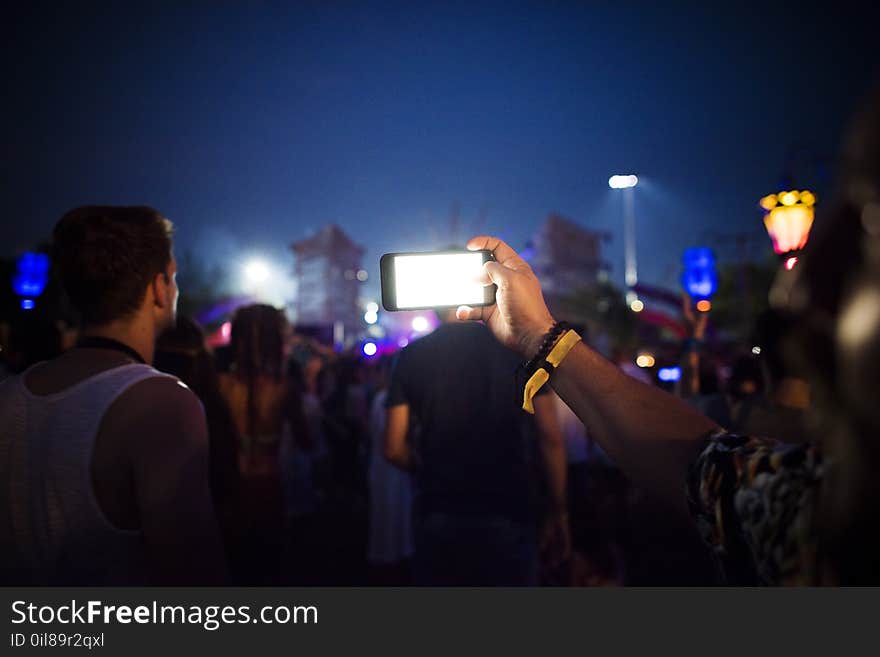 Group of People Using Smartphones during Nighttime