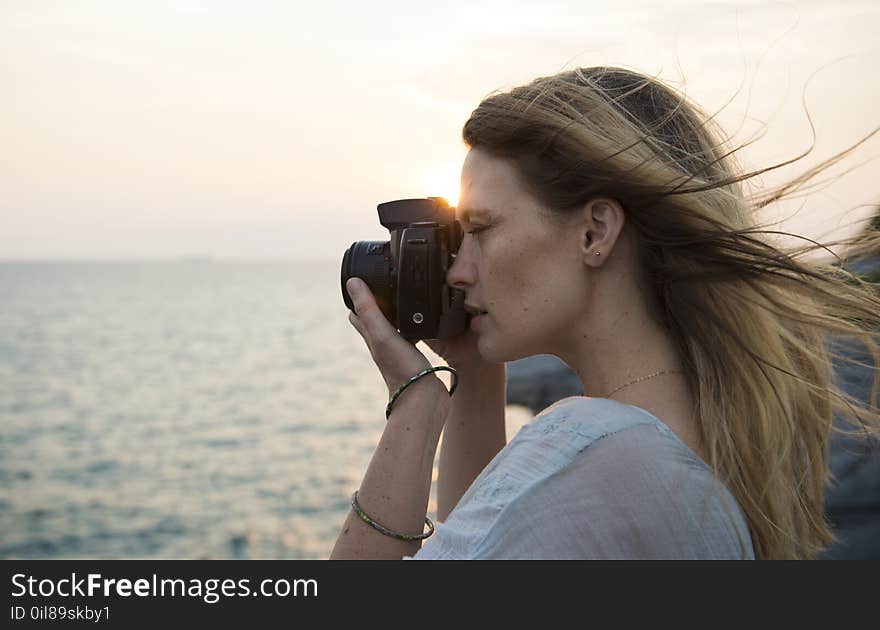 Woman Holding Black Dslr Camera