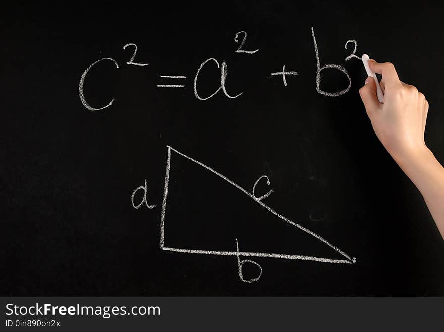 In this captivating close-up image, a young female hand delicately writes the Pythagoras Theorem on a traditional school blackboard using a white chalk. The composition highlights the intersection of business and education, showcasing the importance of mathematical principles in various fields. The precise strokes and attention to detail demonstrate the significance of understanding and applying this fundamental theorem. The close-up perspective allows viewers to appreciate the texture and authenticity of the chalkboard, adding a nostalgic touch to the image. Whether you're designing educational materials, promoting STEM programs, or emphasizing the value of mathematical knowledge, this image serves as a powerful visual representation of the timeless impact of Pythagoras Theorem. In this captivating close-up image, a young female hand delicately writes the Pythagoras Theorem on a traditional school blackboard using a white chalk. The composition highlights the intersection of business and education, showcasing the importance of mathematical principles in various fields. The precise strokes and attention to detail demonstrate the significance of understanding and applying this fundamental theorem. The close-up perspective allows viewers to appreciate the texture and authenticity of the chalkboard, adding a nostalgic touch to the image. Whether you're designing educational materials, promoting STEM programs, or emphasizing the value of mathematical knowledge, this image serves as a powerful visual representation of the timeless impact of Pythagoras Theorem