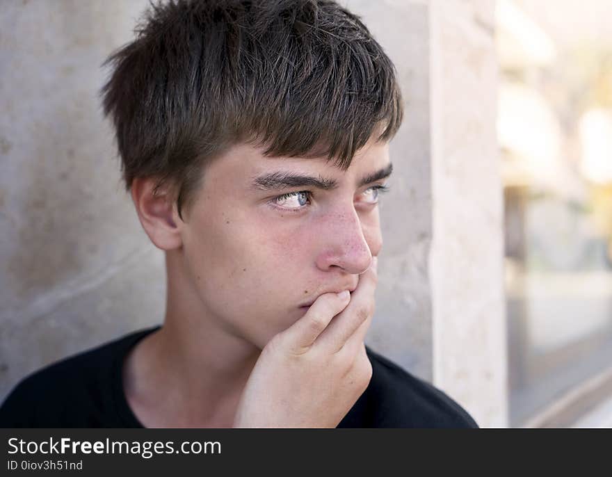 Portrait of a young man leaning on his hand