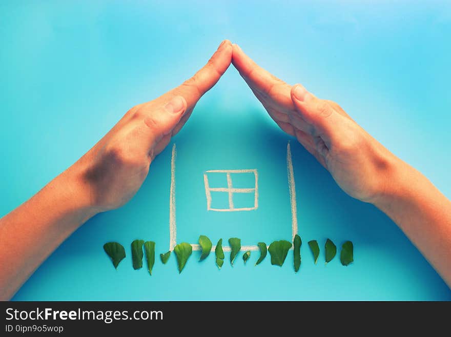 Sketch of a house with hands making a roof