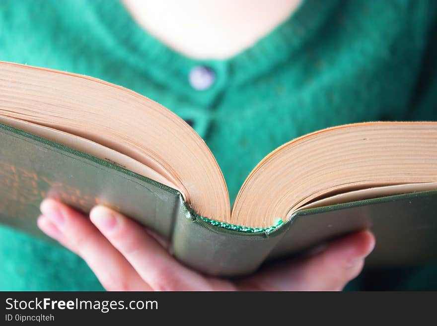 Girl with a book in green clothes