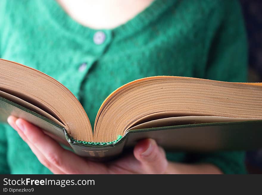 Girl with a book in green clothes