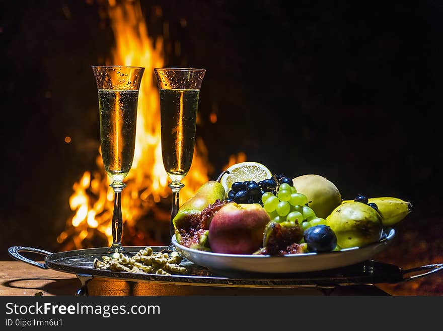 Still life with champagne on the background of fire