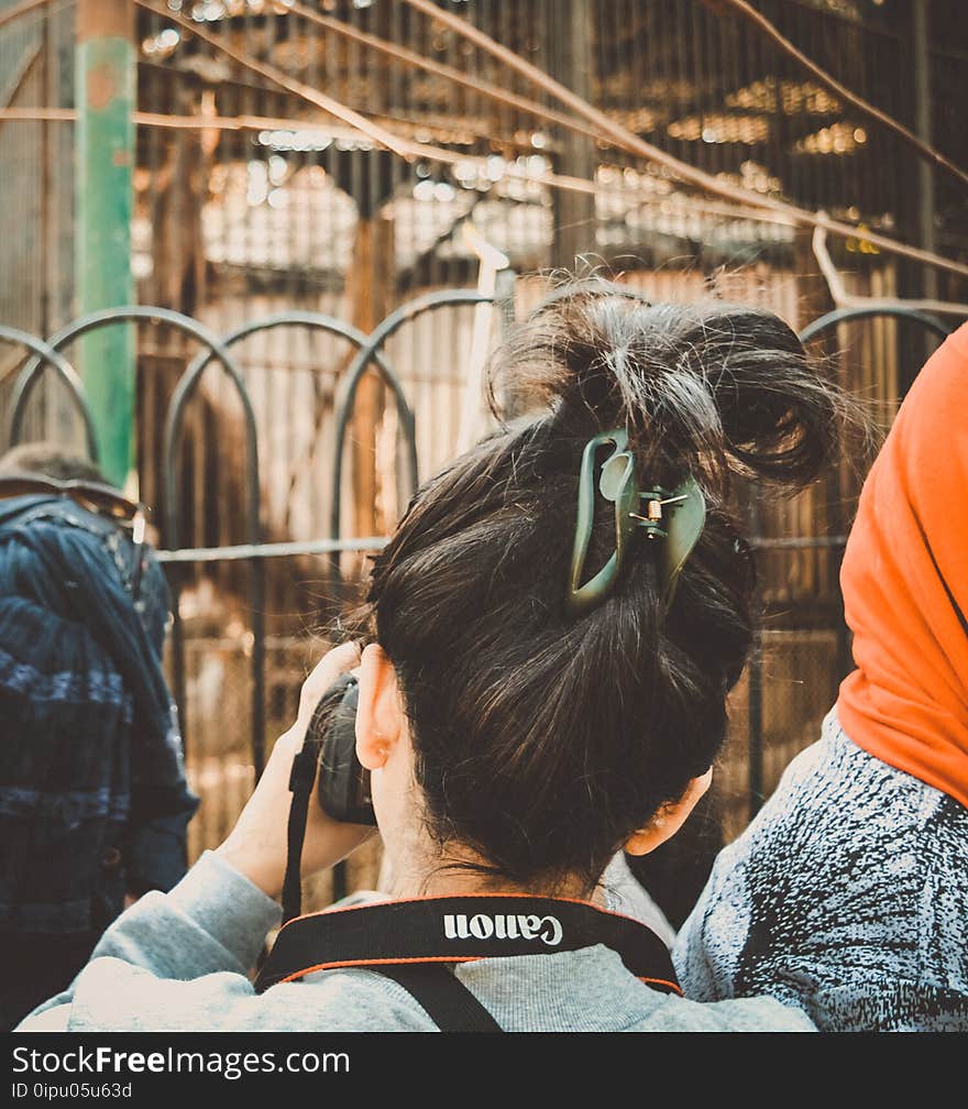 Woman Taking Photograph Using Canon Dslr Camera