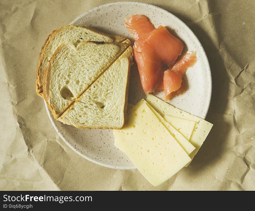 Bread, Cheese, And Raw Meat On Plate