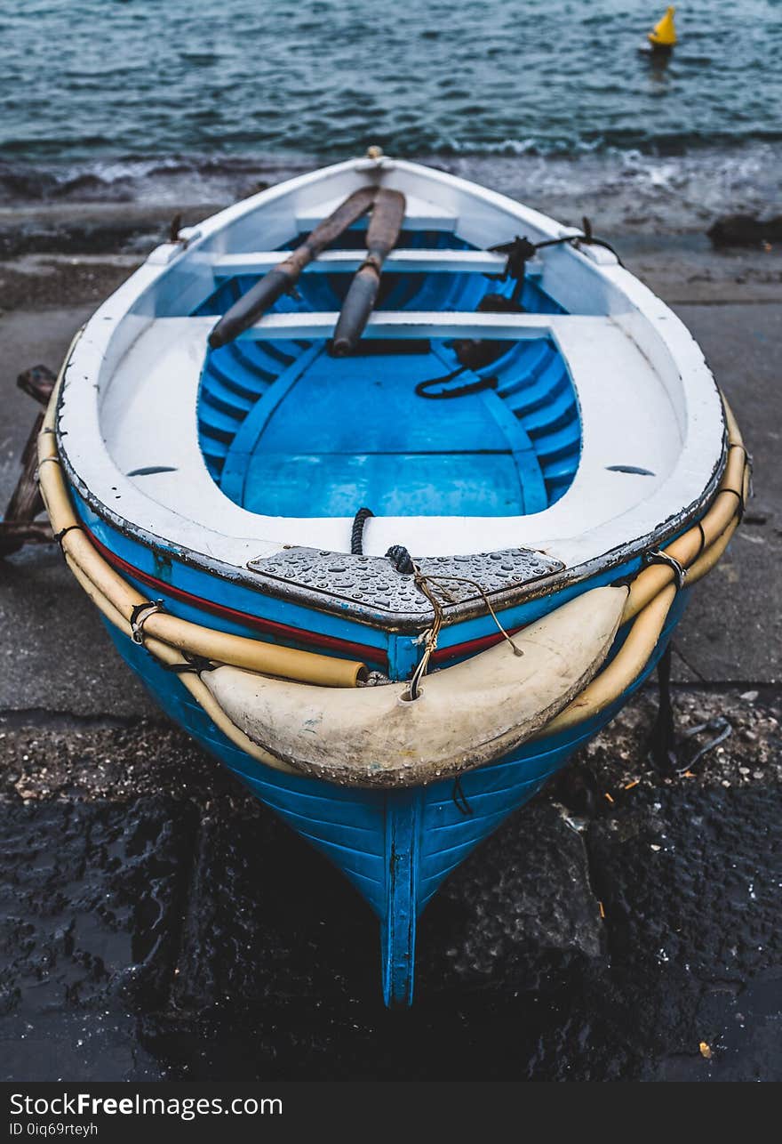 White and Blue Wooden Boat on Seashore