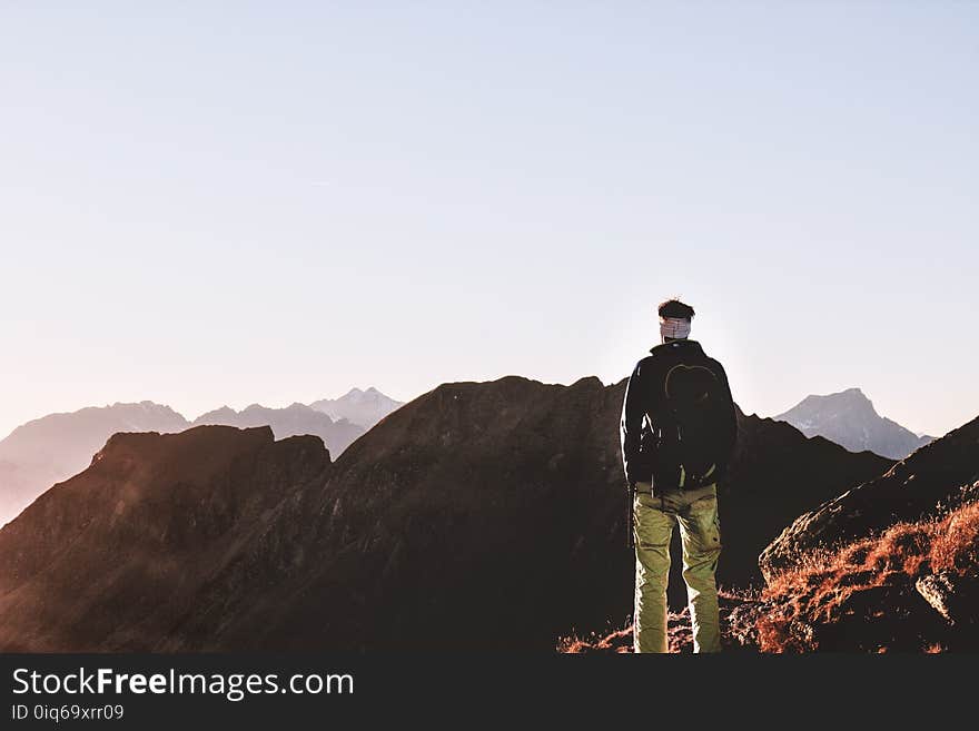 Person Standing on Top of the Mountain