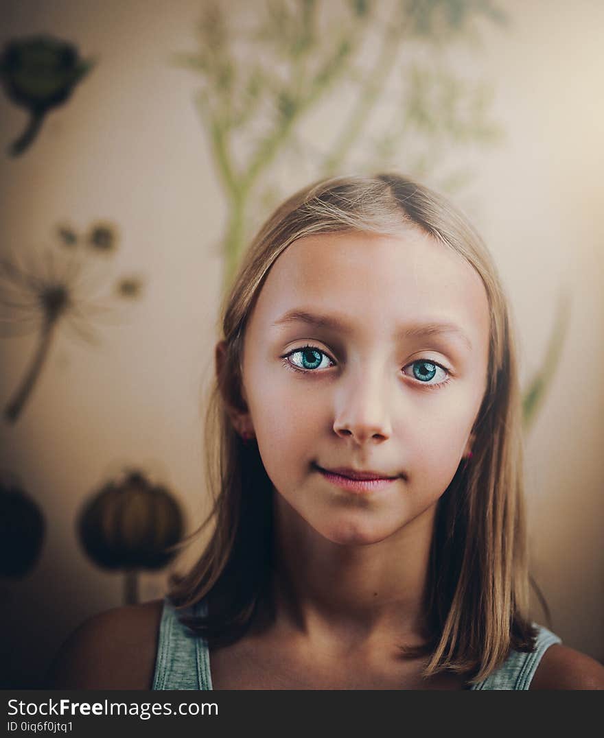 Smiling Girl Standing in White Painted Wall Room