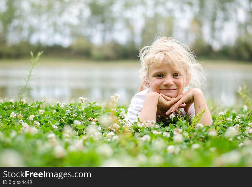 Little lovely girl lying on the grass and enjoying life. Little lovely girl lying on the grass and enjoying life