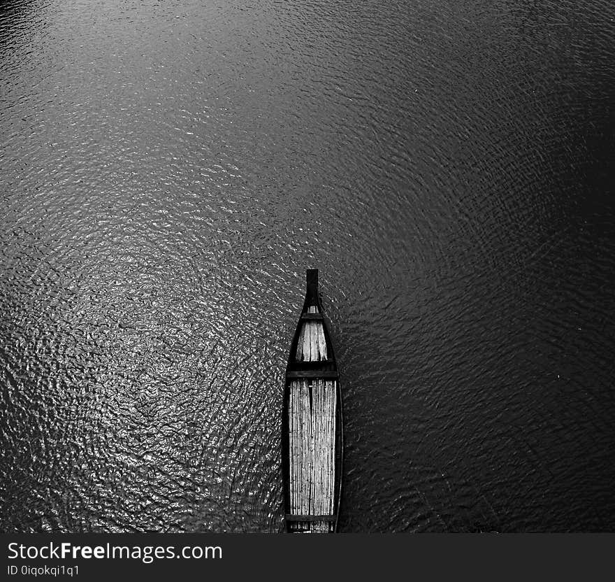 Aerial View Black Wooden Row Boat on Body of Water