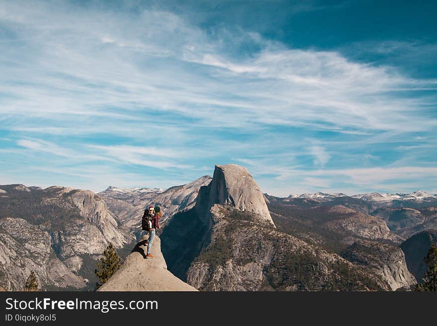 Woman With Baby At The Peak Of A Mountain