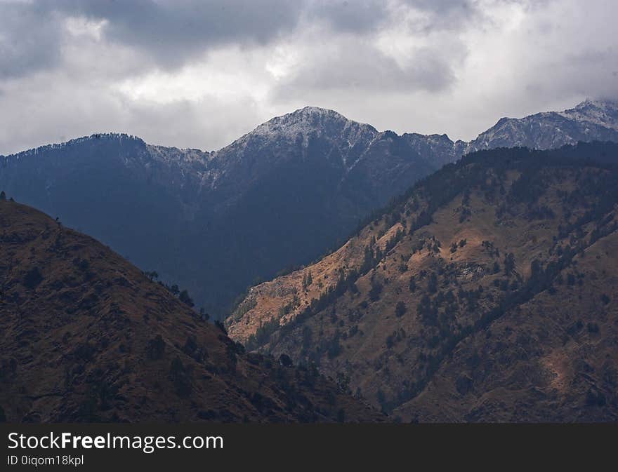 Brown Mountain Under White Cloudy Sky