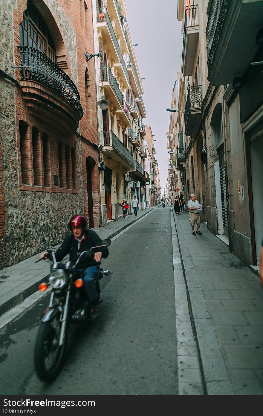 Man Riding Black Standard Motorcycle