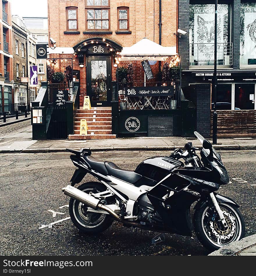 Black and White Yamah Sport Bike Parked Outside Belts Store Facade