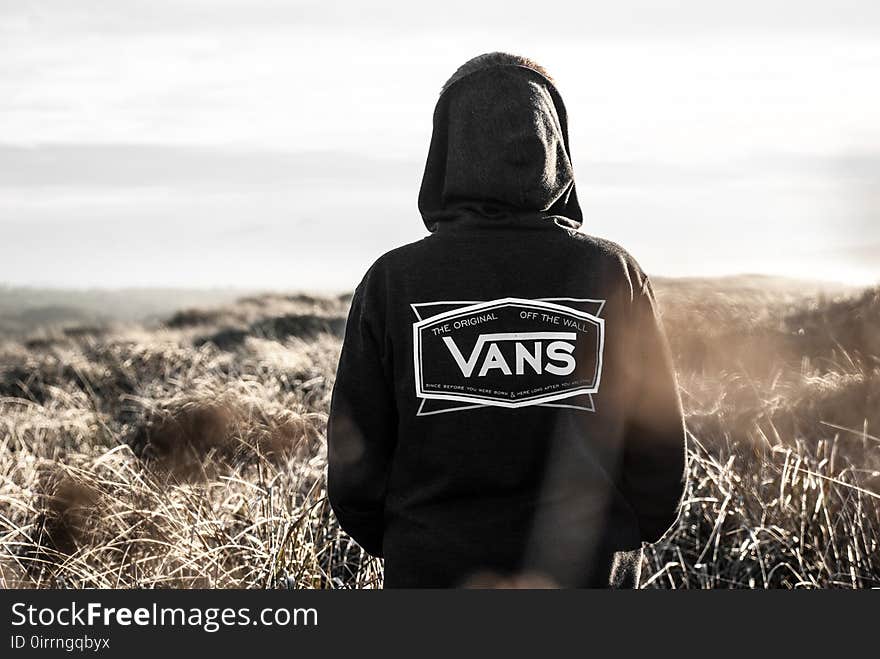 Photo Of Person Wearing Black Vans Hoodie