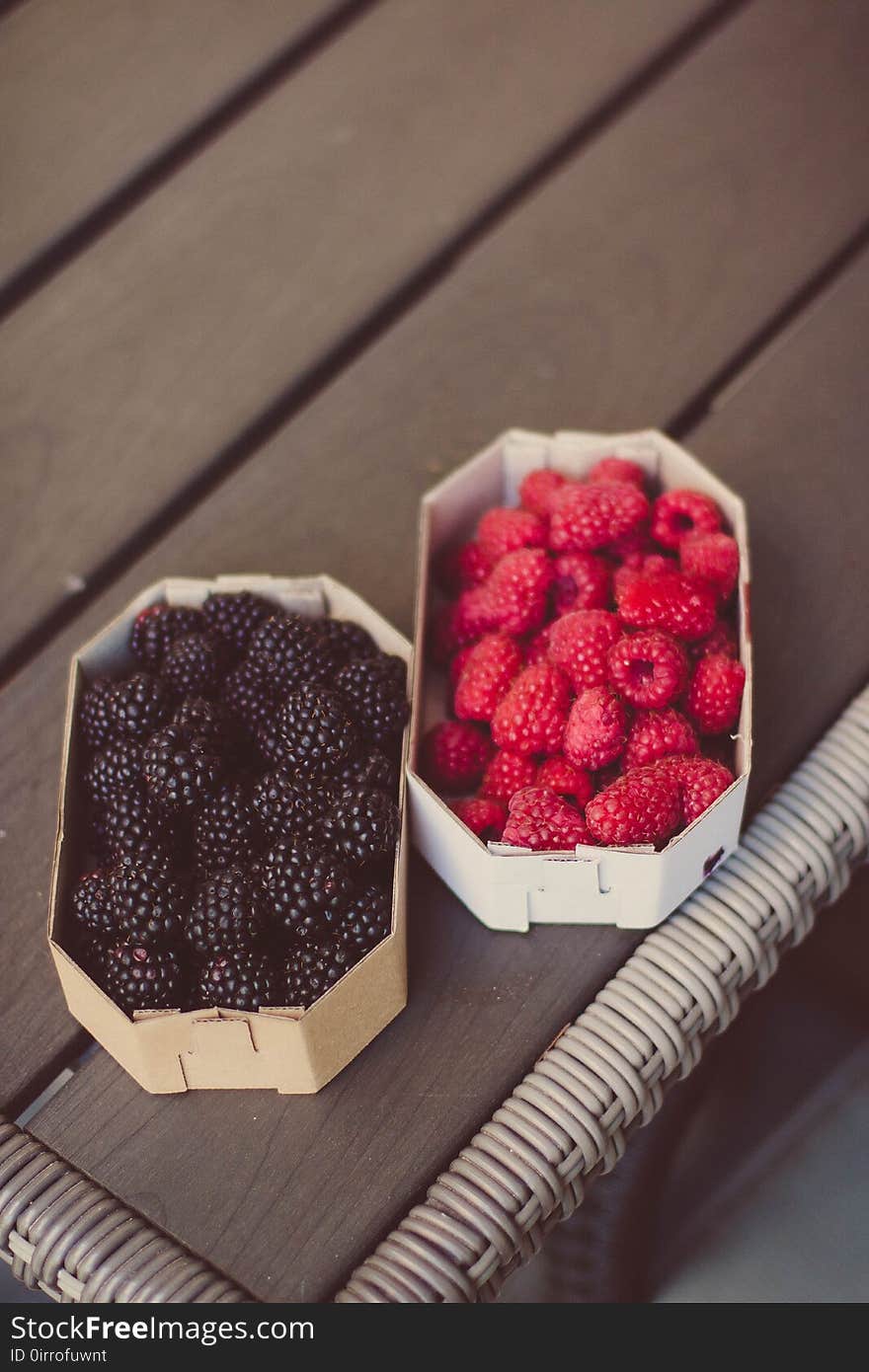 Raspberries And Blueberries On Top Of Table