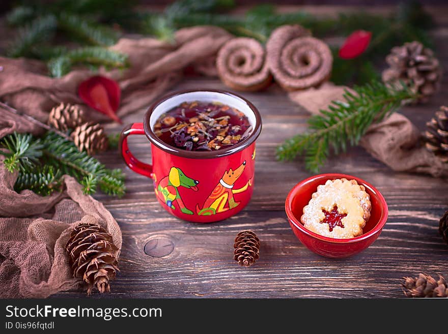 Fruit tea and Christmas cookies in a brown ceramic bowl on a Christmas background