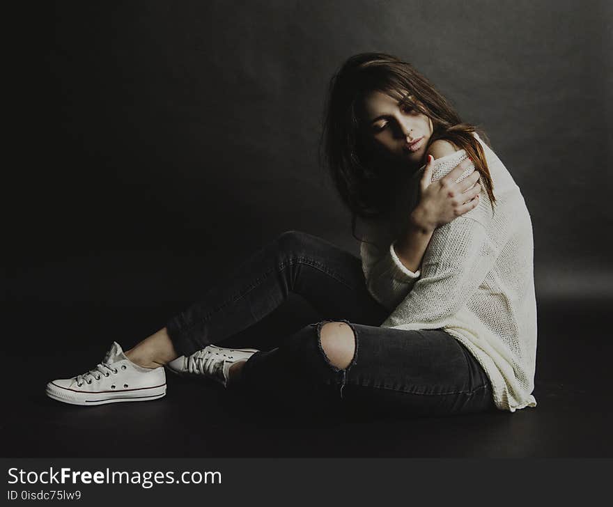 Woman in White Top and Black Distress Jeans