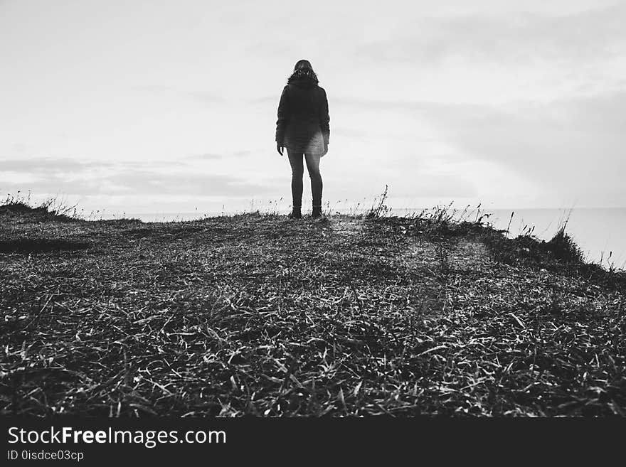 Grayscale Photo Of Person In Parka Coat