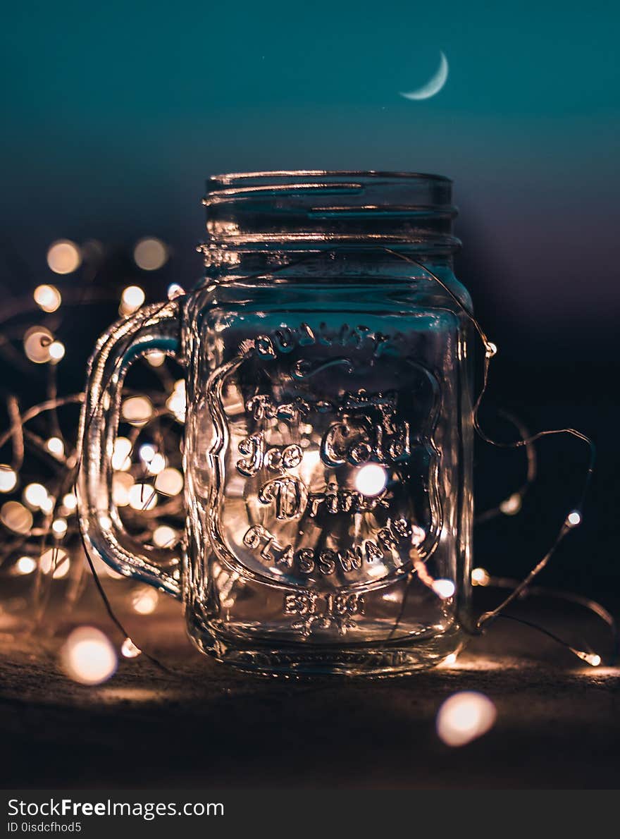 Shallow Focus Photograph of Clear Glass Mason Jar With Fairy Lights