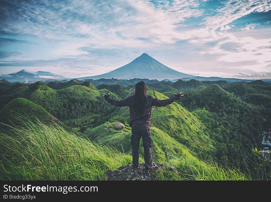 Person Standing on Top Of Hill