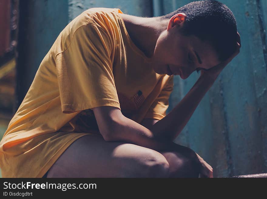 Woman In Yellow Shirt Resting Left Hand On Head