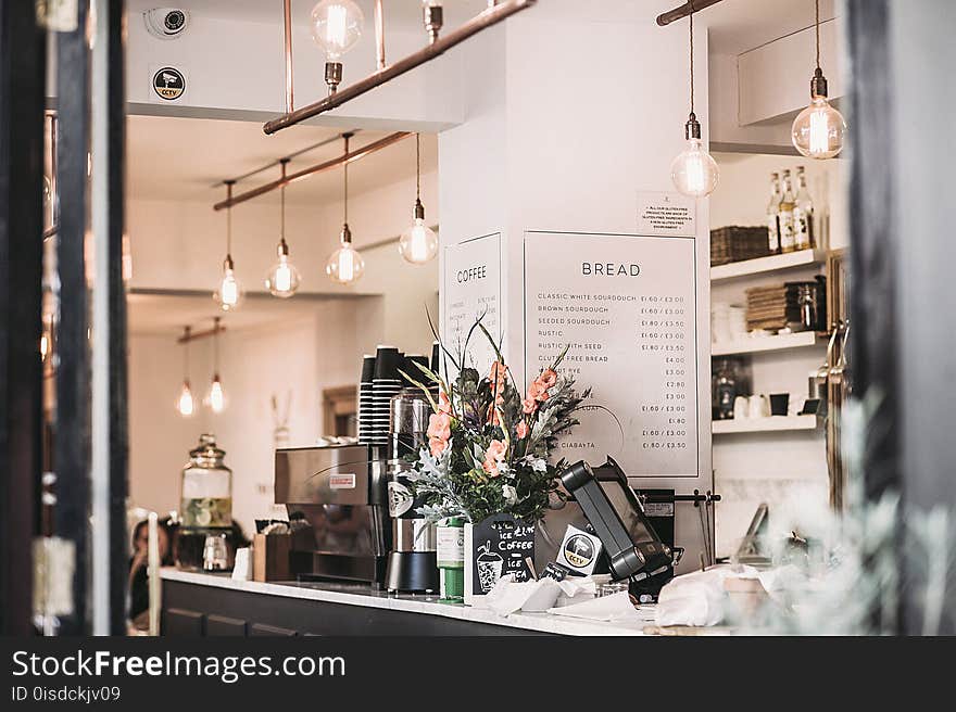 Inside the Restaurant With Pendant Lamps and Flowers