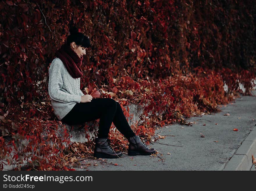 Woman Sitting on the Pavement