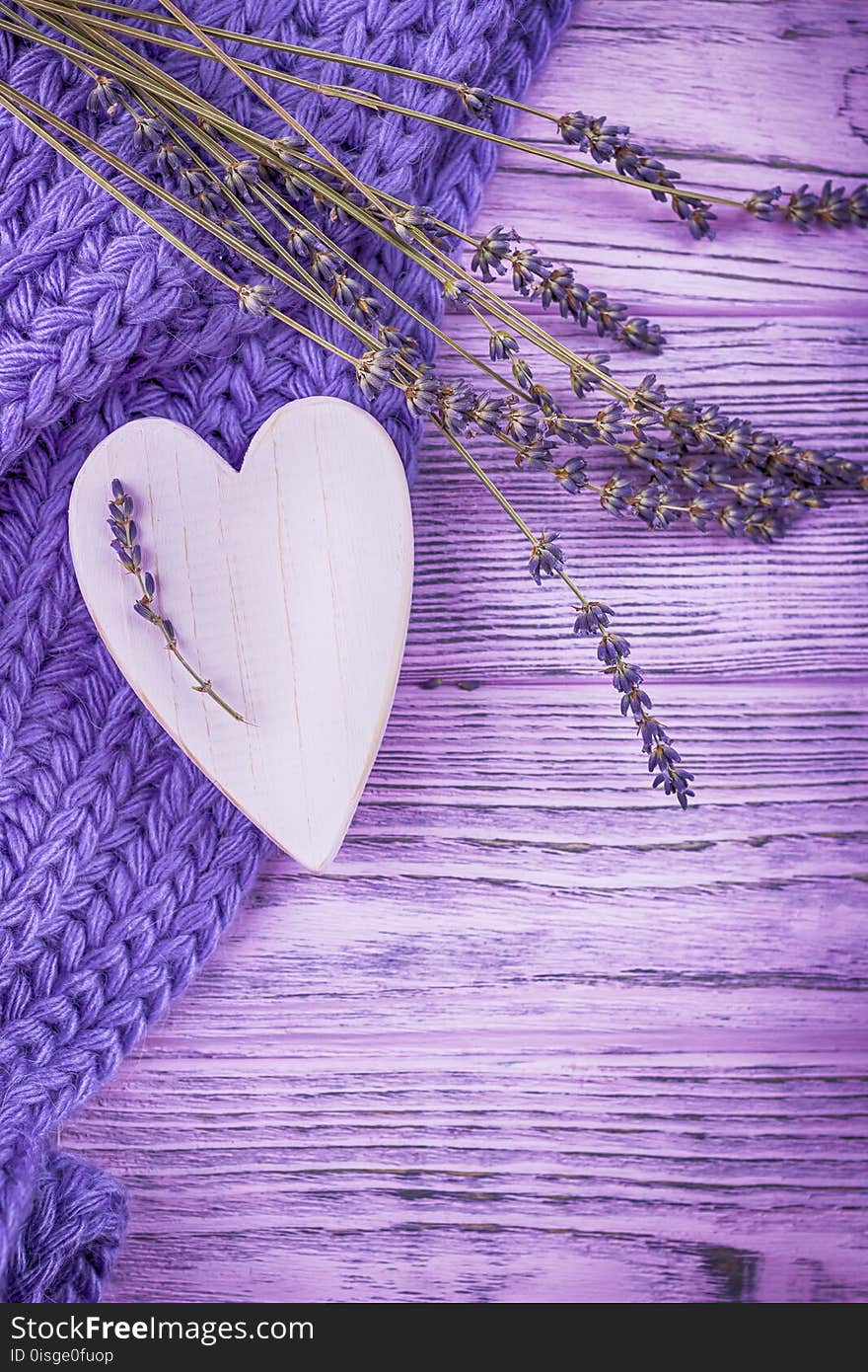 Happy Valentine`s Day. Wooden heart and lavender flowers on a lilac wooden background