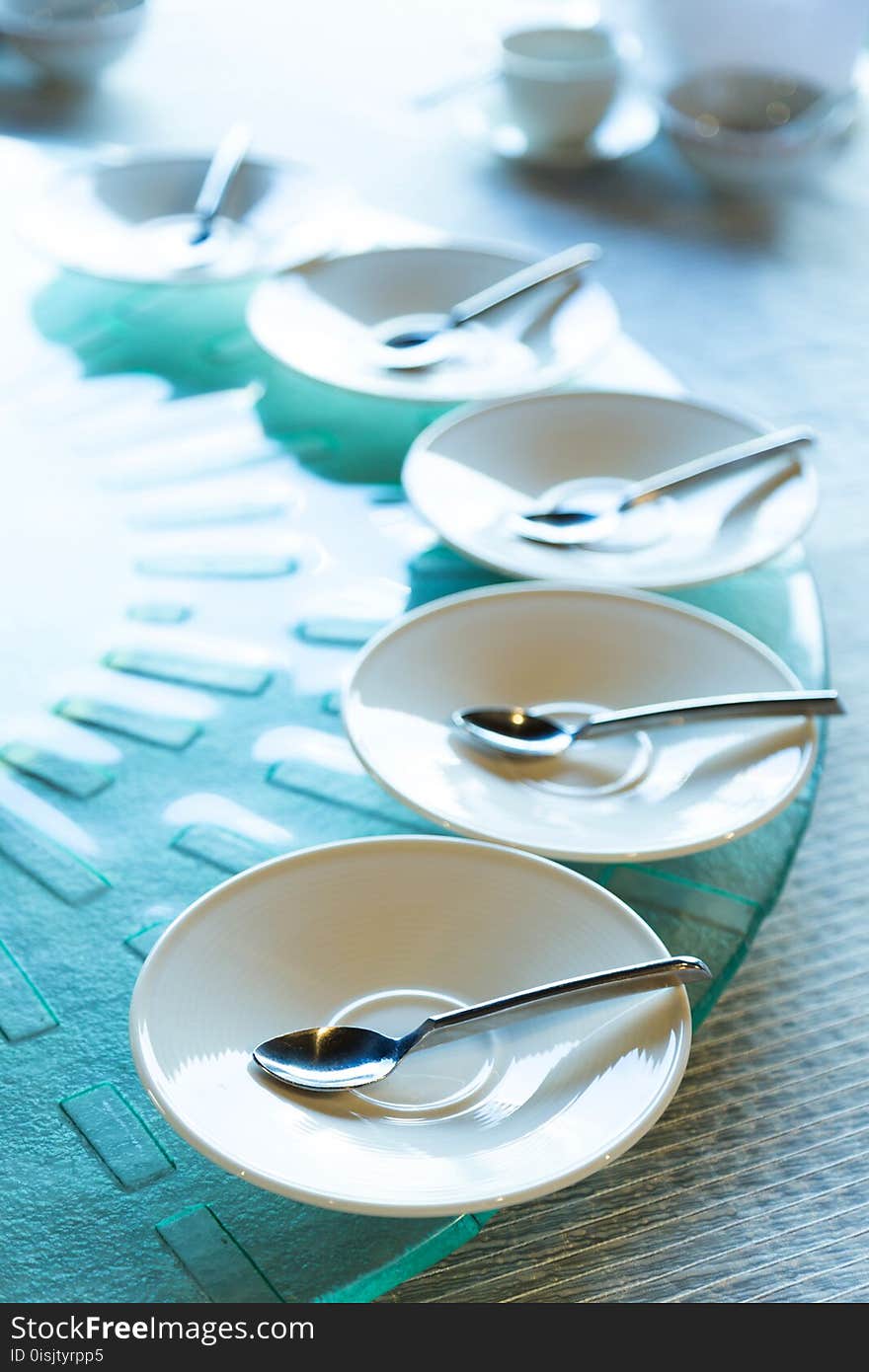 Spoon in the white dish on the food table, selective focus