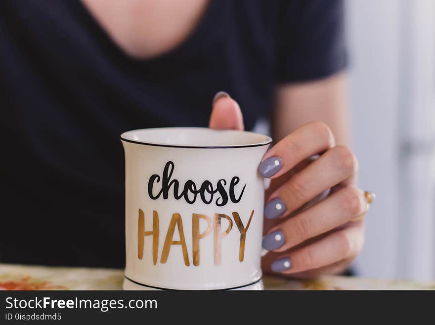 Selective Focus Photography of Person Touch the White Ceramic Mug With Choose Happy Graphic